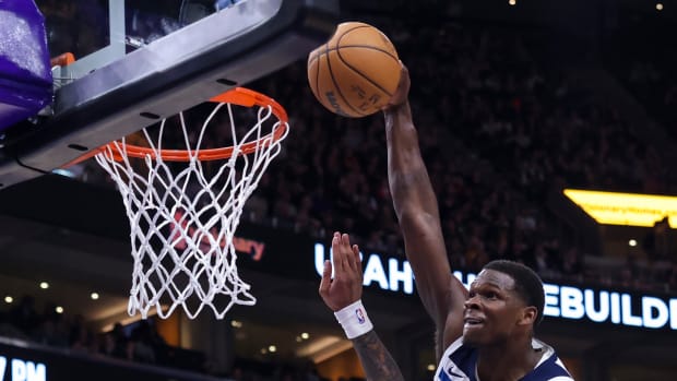 Minnesota Timberwolves guard Anthony Edwards (5) dunks the ball against Utah Jazz forward John Collins (20) during the third quarter at Delta Center in Salt Lake City on March 18, 2024.